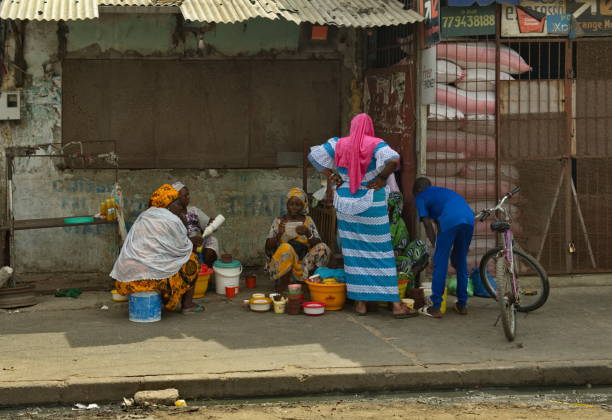 Saint-Louis. Senegal. October 10, 2021. Residents of the sea fishermen's quarter discuss everyday problems at the entrance of a residential building.