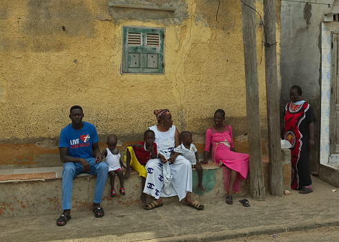 Saint-Louis. Senegal. October 10, 2021. Residents of the sea fishermen's quarter discuss everyday problems at the entrance of a residential building.
