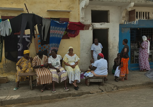 Saint-Louis. Senegal. October 10, 2021. Residents of the sea fishermen's quarter discuss everyday problems at the entrance of a residential building.