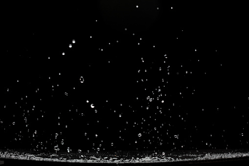 Shape form droplet of Water splashes into drop water attack fluttering in air. Splash Water for texture graphic resource elements, black background isolated selective focus blur