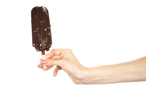 Ice cream covered with chocolate and almonds sticks in hand isolated on white background. High quality photo