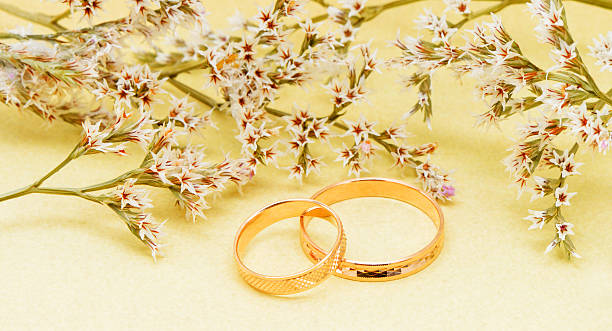 istock Gold wedding rings and branch flowers 158038449