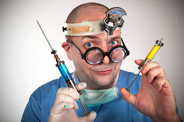 istock Wacky doctor with two syringes ready to give an injection 158038728