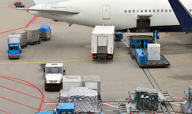 istock Baggage carts and food truck loading a jet airplane 158038904