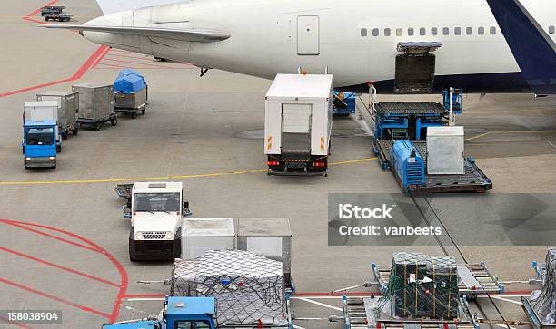 Baggage Carts And Food Truck Loading A Jet Airplane Stock Photo - Download Image Now