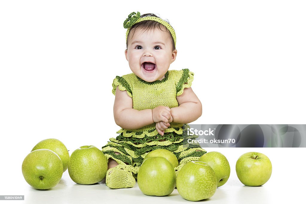 happy baby with green apples isolated on white background Activity Stock Photo