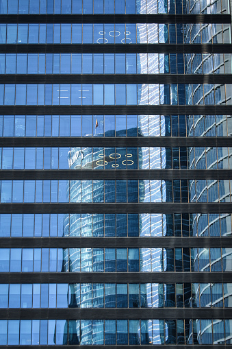 Buildings reflected in the glass of another building