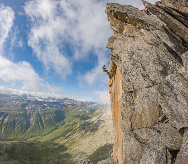 istock Mountaineers ascend to mountain summit 1580427532