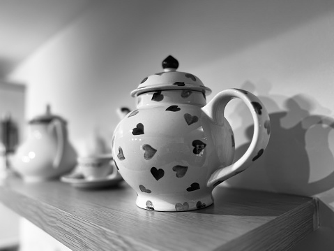 A teapot decorated with hearts