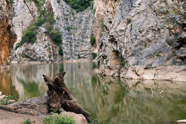 istock Explore a deep cliff-high canyon in an old, flooded mine. 1580431668