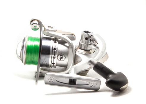 Fishing reels is a leisure sport or hobby of the unemployed, fishing is a popular thing for people to fish to eat and is a sport on a white background.