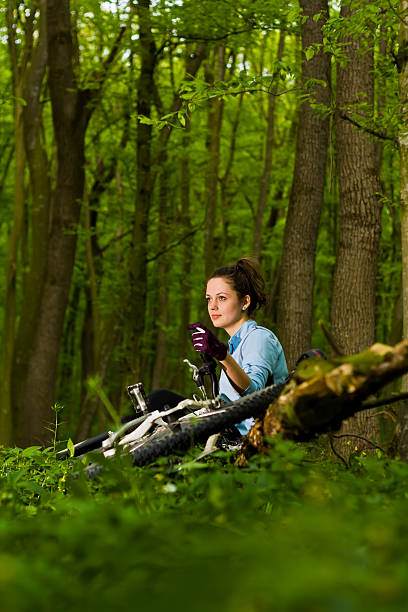 istock girl with bicycle the forest 158052389