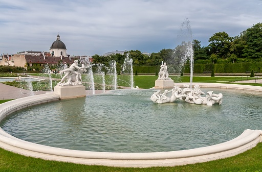 Idyllic view on Pond in Kadriorg   and fountain  inside pond and small island with trees and white alcove