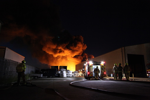 Industrial building  fire fully enveloped in fire. flammable manufacturing products burning