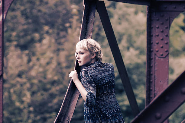 istock young woman standing on bridge bearing 158063170