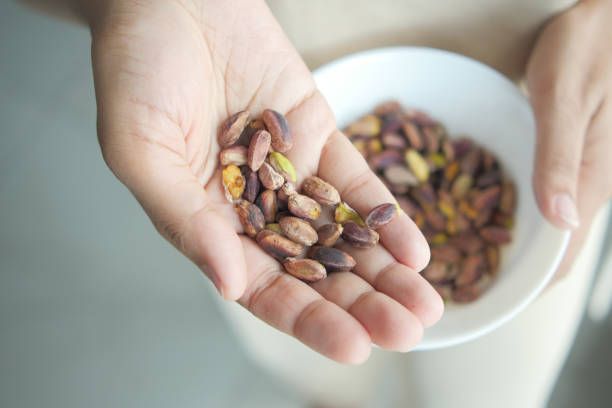 istock close up of pistachios nut on hand 1580663741
