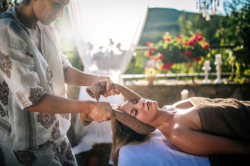 Beautiful woman receiving head thai massage in spa salone