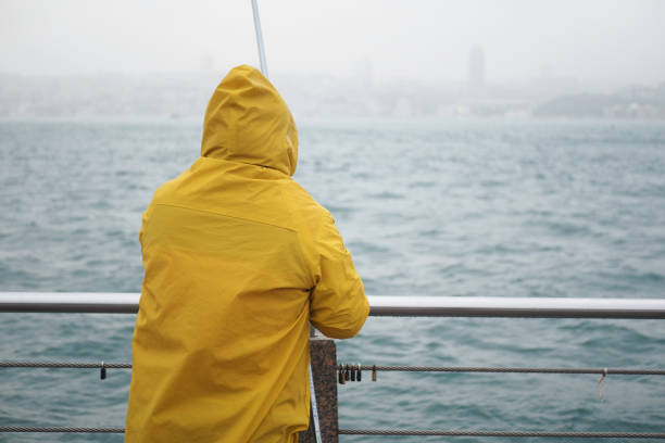 istock Fisherman with yellow rod, spinning reel 1580675839