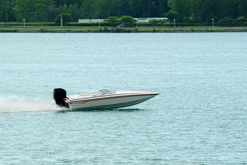 speeding white power boat on the st clair river ontario