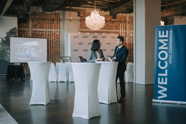 istock Asian Chinese businesswoman final check going through programme details with banquet hall manager before the business conference seminar begin 1580739875