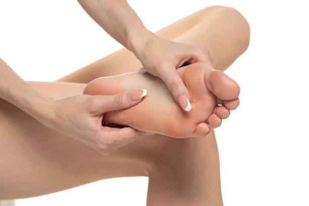 istock woman massaging her painful foot on white studio background 1580758931
