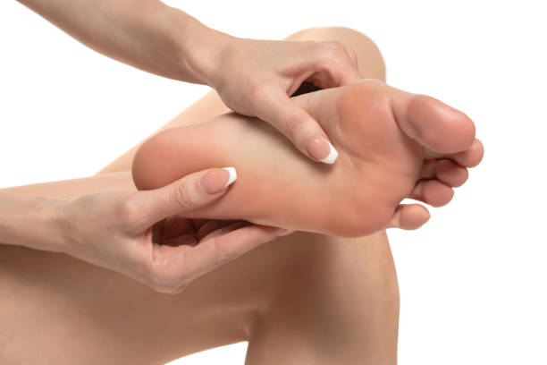 istock woman massaging her painful foot on white studio background 1580759017
