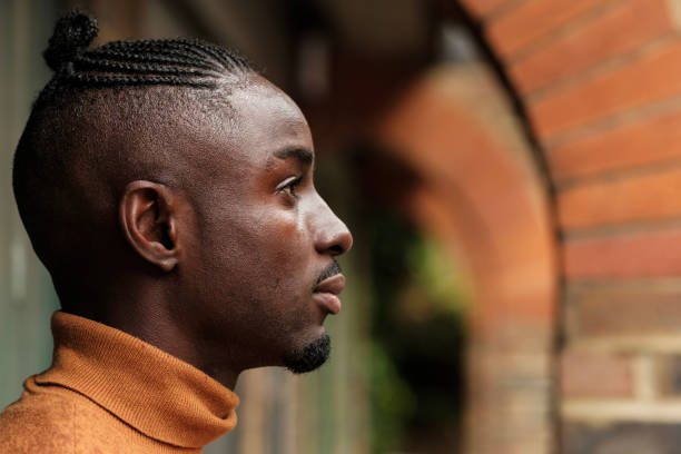 istock Head-shot of black male model seen from side. 1580767028