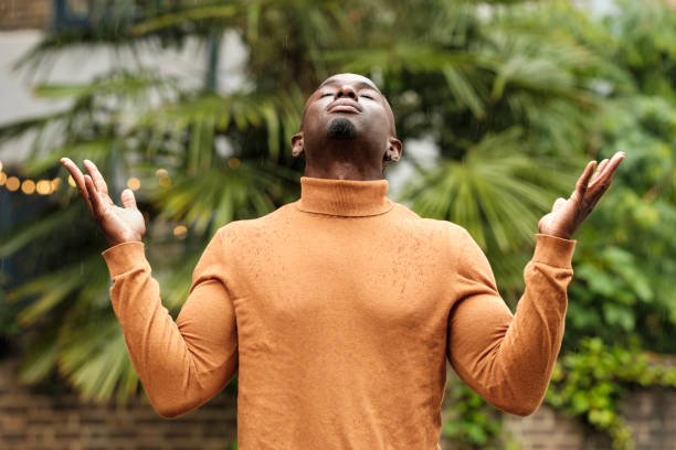 Dramatic image of black male under the rain.