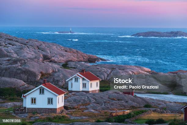 Isolated Houses In The Rocky And Wild Landscape Surrounded Rough Sea Stock Photo - Download Image Now