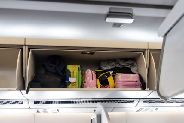 istock Overhead storage for bags and luggages on airplane cabin 1580782184