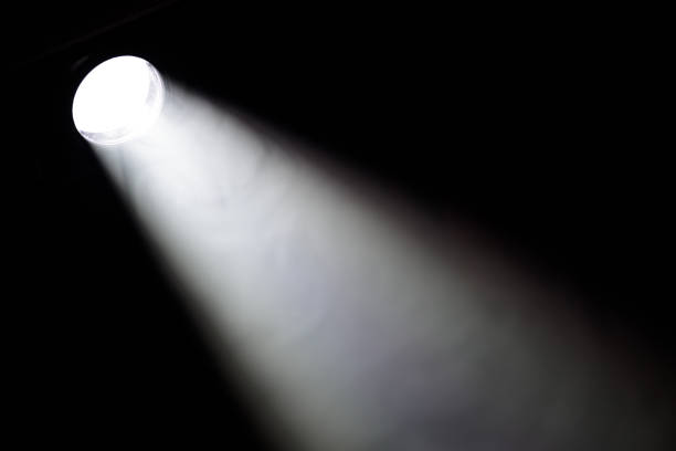 istock spotlight light in the dark, bright beam of light light and darkness 1580783167