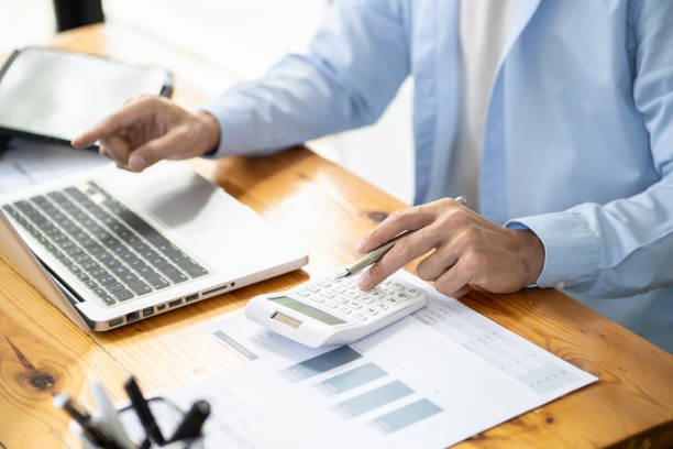 istock Asian businessman  In the Data Mining Center Statistician with Monitors Displaying business finance technology and investment. Stock Market Investments 1580791668