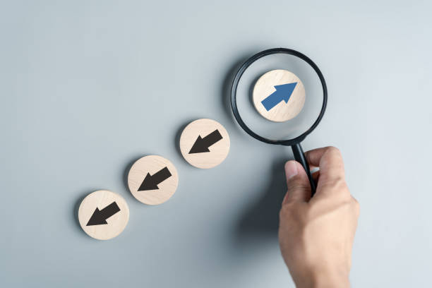 istock Hand holding Blue arrow and different direction facing opposite direction with black arrow for business disruption and technology transformation and different thinking idea concept 1580808771