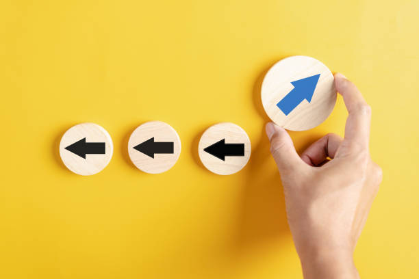 istock Hand holding Blue arrow and different direction facing opposite direction with black arrow for business disruption and technology transformation and different thinking idea concept 1580809300
