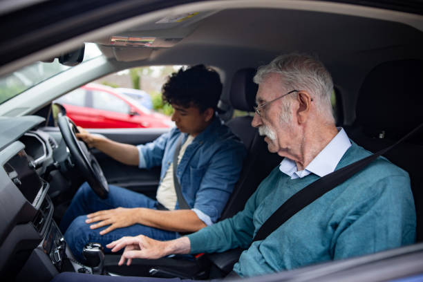 Instructor teaching young man how to drive in England