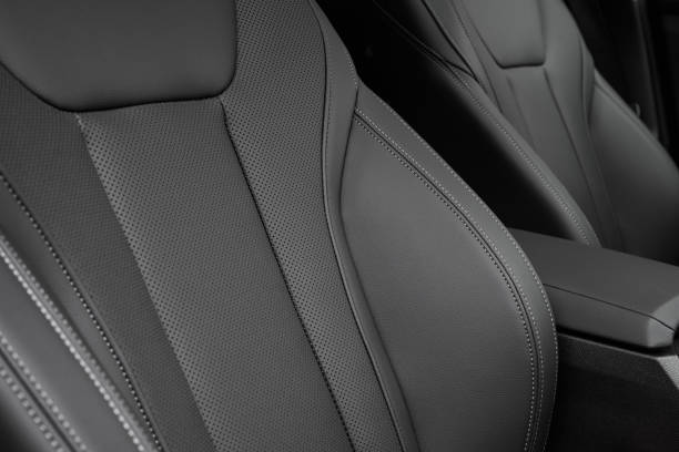 istock Black Perforated Leather Seat White Stitching Closeup 1580819659