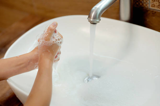 Little girl washing hands with water and soap in bathroom. Hands hygiene and virus infections prevention girl washing hands with water and soap in bathroom. Hands hygiene and virus infections prevention water sanitation worker washing faucet stock pictures, royalty-free photos & images
