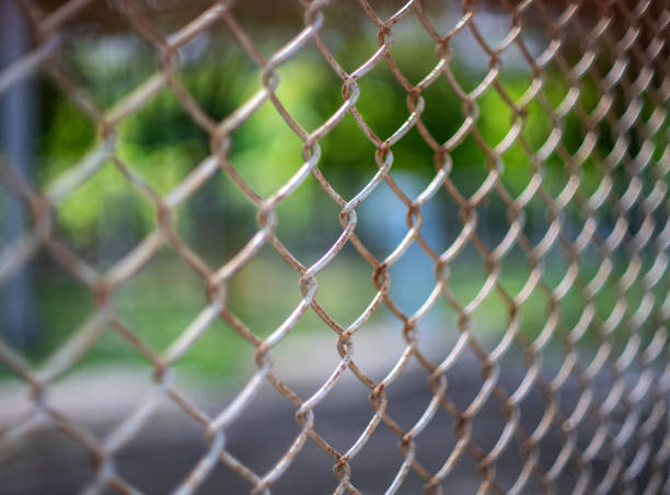 istock Close-up chain link fence , Sunset background 1580852814
