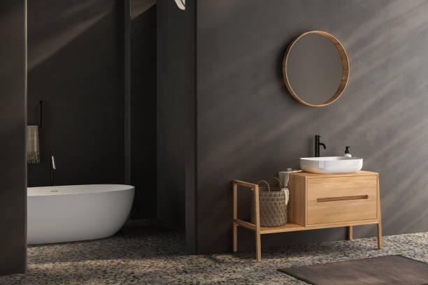 istock Black minimalist bathroom interior with wooden vanity, bathtub, terrazzo floor. 1580857768