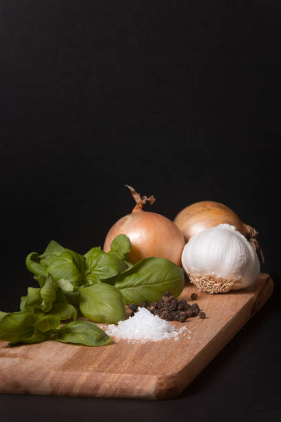 istock Onions, Garlic, Base, salt and pepper artisticly placed on a serving tray. 1580869941