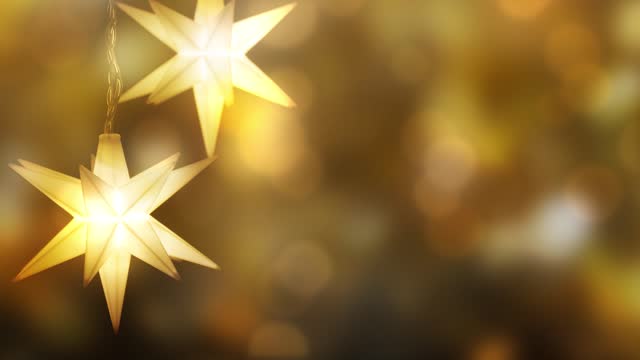 hanging bright christmas star decoration on blurred golden bokeh light animation background, shiny abstract merry xmas backdrop concept with space for text or product presentation