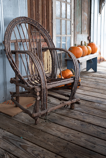 Amish rocking chair on a porch with pumpkins in Nolensville, Tennessee.