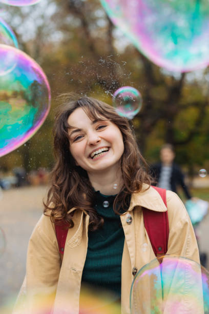 istock Woman standing among soap bubbles in the park 1580896228