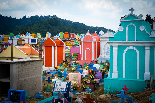 Chichicastenago, Guatemala- May 21, 2023: Colorful tombs in a row on general cemetery in Chichicastenango, Guatemala