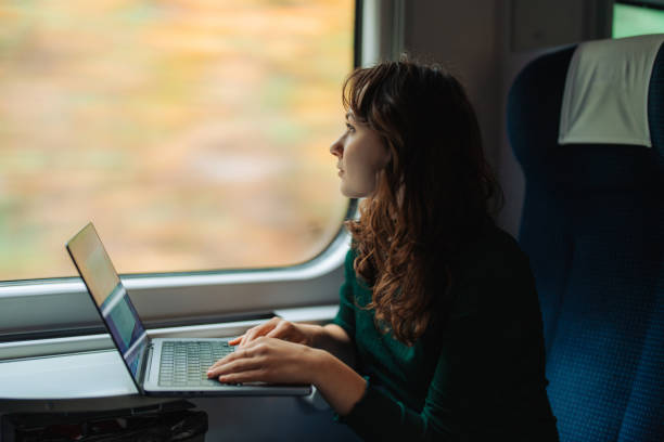 istock Woman working with laptop while traveling by train 1580899659