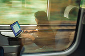 Woman working with laptop while traveling by train