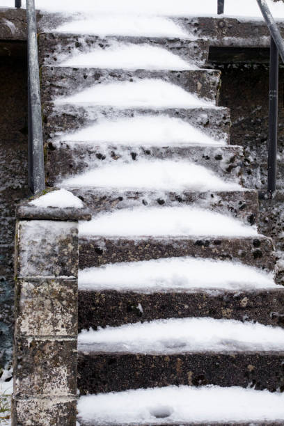 A snow-covered stairway with color signifying that it has been de-iced.