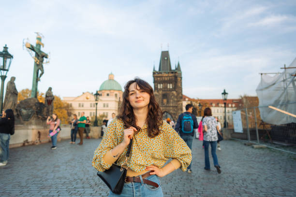istock Woman walking on Karl bridge in Prague 1580902346