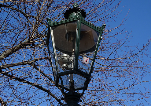 A close-up depiction of a Vintage/Antique gas lantern, on a public park of Dusseldorf, Germany , shot in late January 2023.