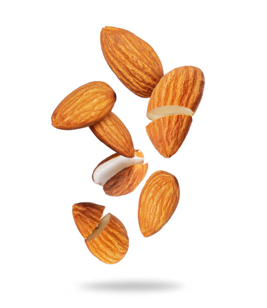 istock Whole and cracked almonds close-up in the air on a white background 1580931496